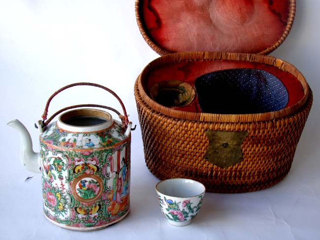 A fine 19th century Chinese Rose Medallion Teapot and cup in their original rattan lidded 'Tea ceremony' basket.